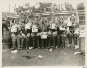 Image of Eskimo [Inughuit] women receiving presents on deck of S.S. Roosevelt